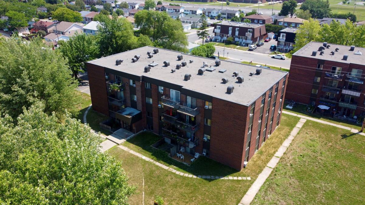 The balcony side of the building and its lawn seen from above