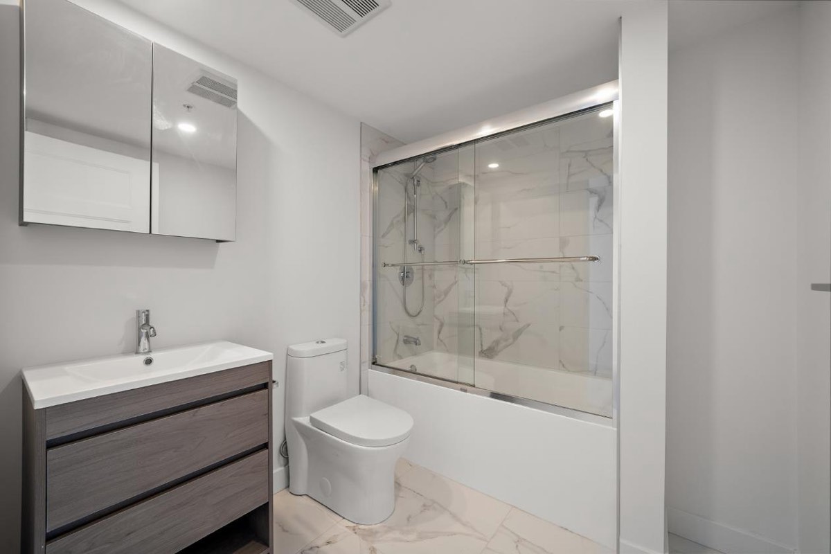 Second bathroom with bath and glass screen