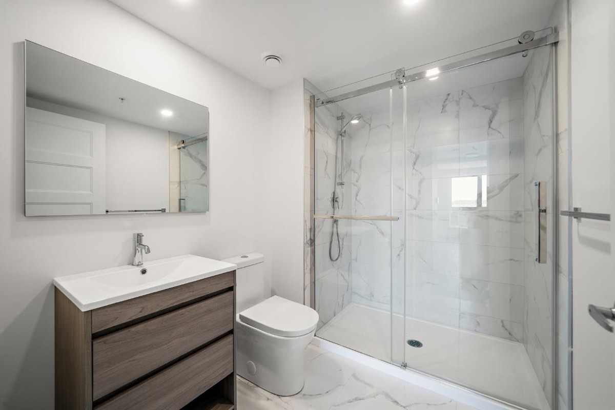 Second bathroom with bath and glass screen