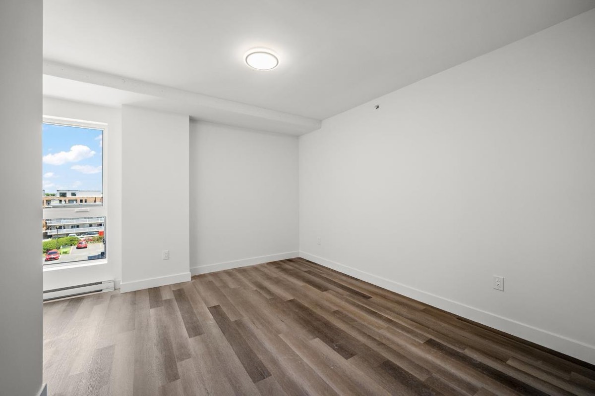 Bedroom with a window over the street