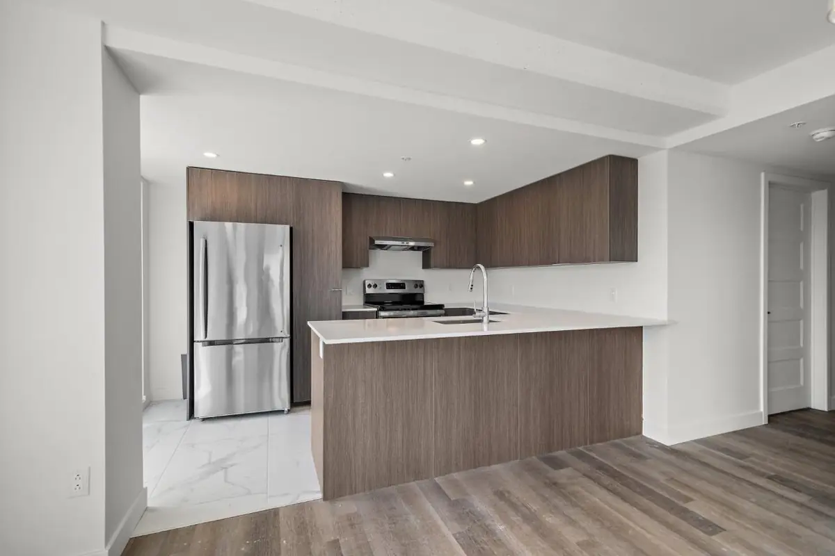 Kitchen with quartz counters and stainless appliances, at Tour Laroche, 6311 boul. Gouin Ouest, Montréal