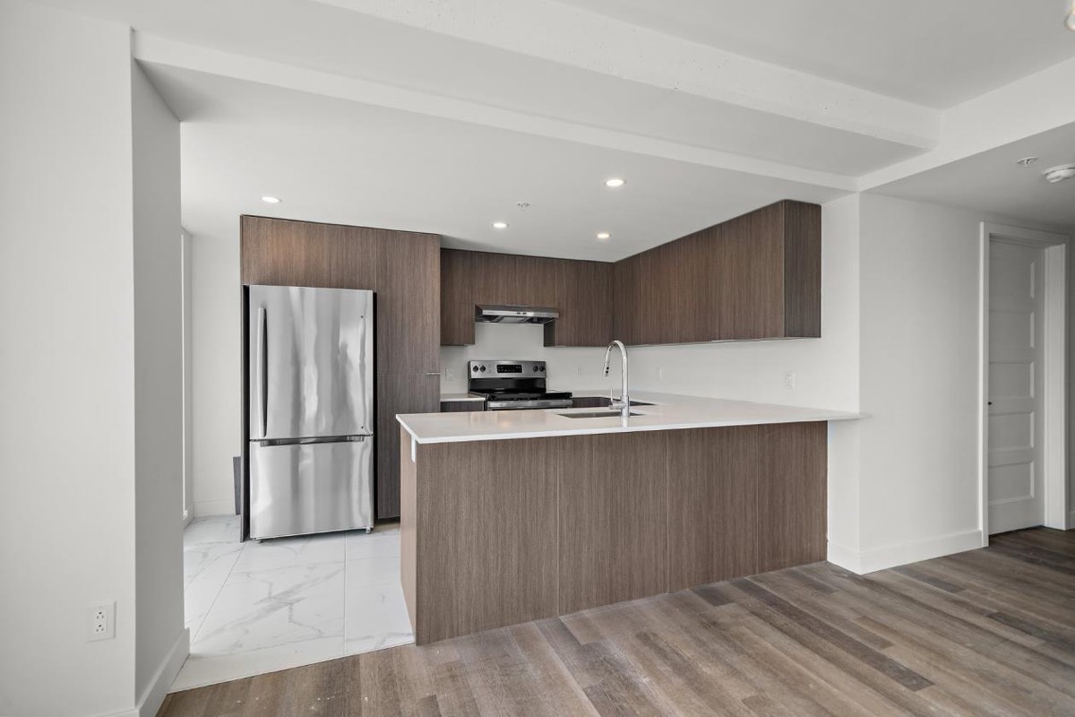 Walnut kitchen with quartz counters at 6311 boulevard Gouin Ouest