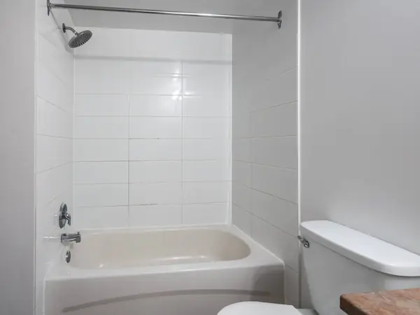 Bath with tiled surround.
