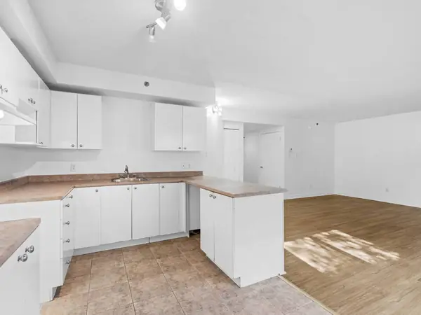 Kitchen with an island counter opening onto the main room.