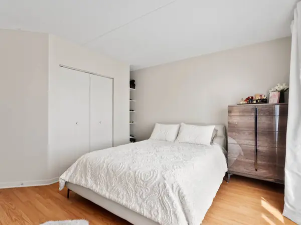 Staged main bedroom with a double closet.