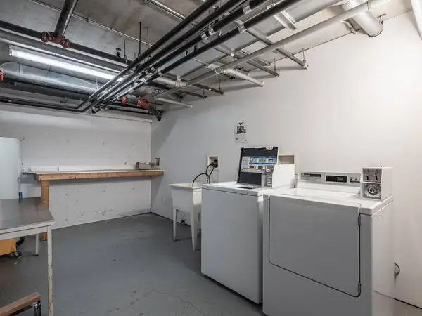 The shared laundry room with washers and dryers.
