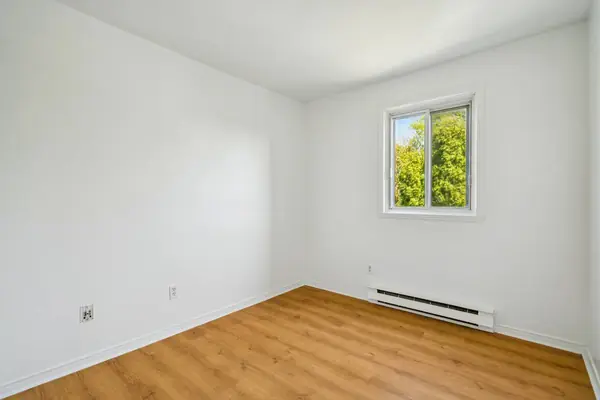 Empty second bedroom with a window