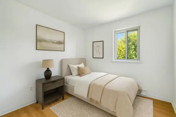 Staged second bedroom with a single bed
