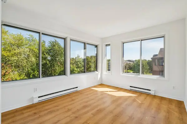 Empty third bedroom with windows on two walls