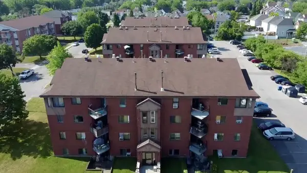 The brick buildings of Place Mercier and their parking, from the air