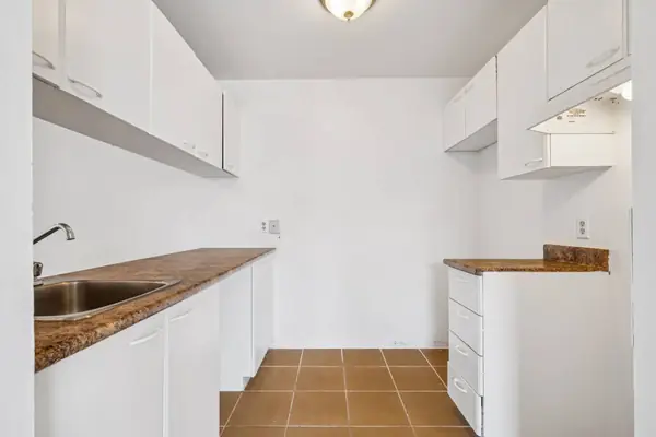 Kitchen with white cabinets and a double sink