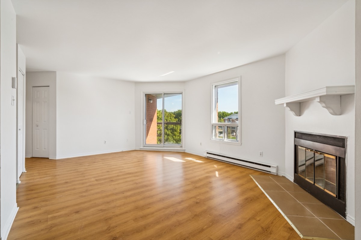 Living room with fireplace at Place Mercier, Candiac