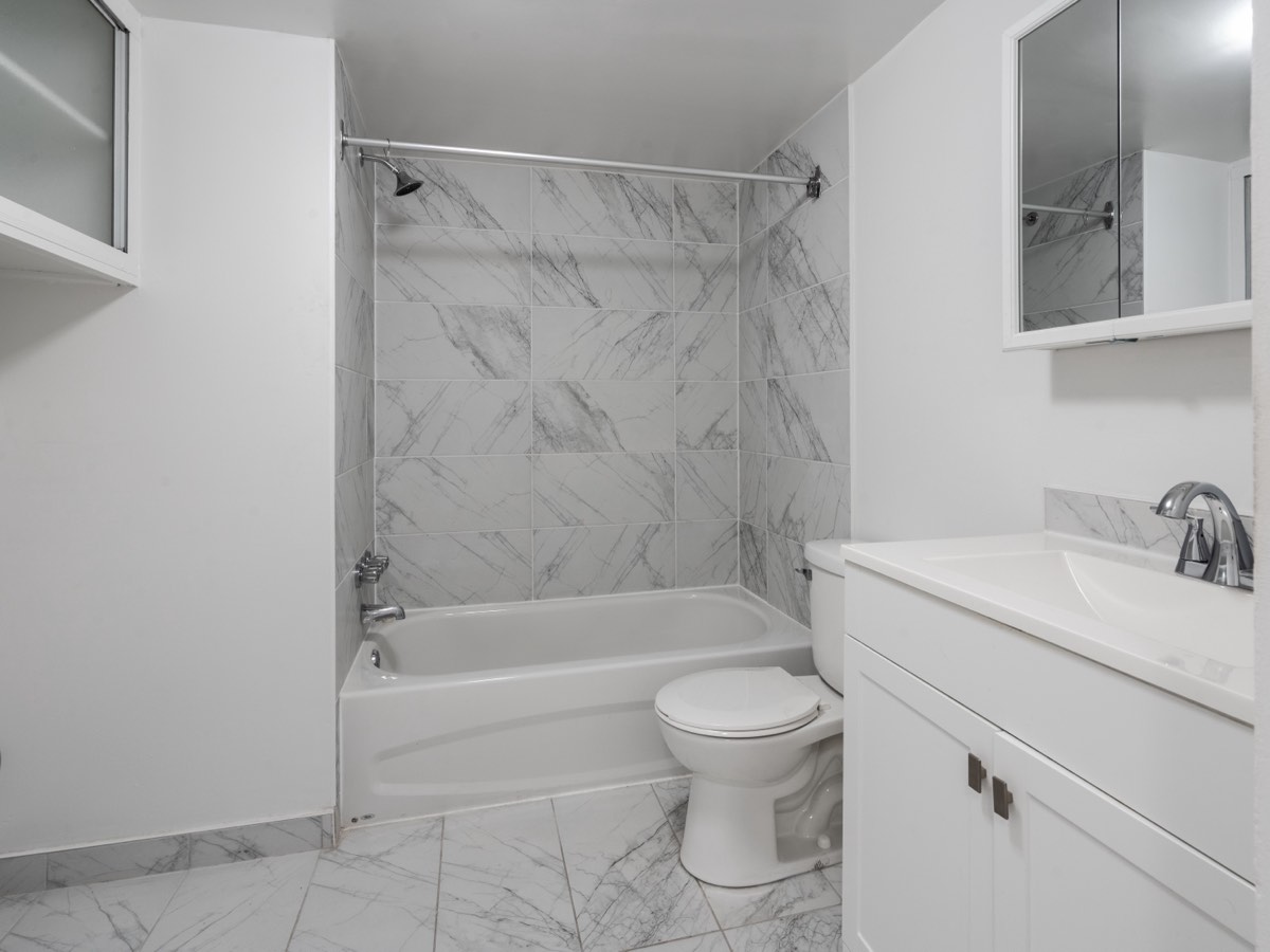 Bathroom with marble-look tiling