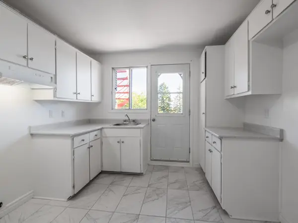 Kitchen with rear door to the grounds