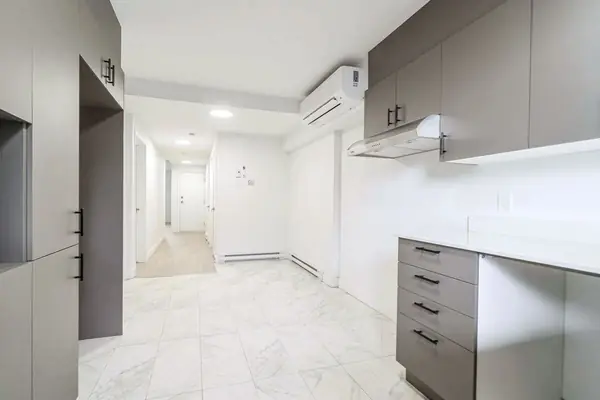 Kitchen with grey cabinets, looking toward the hall