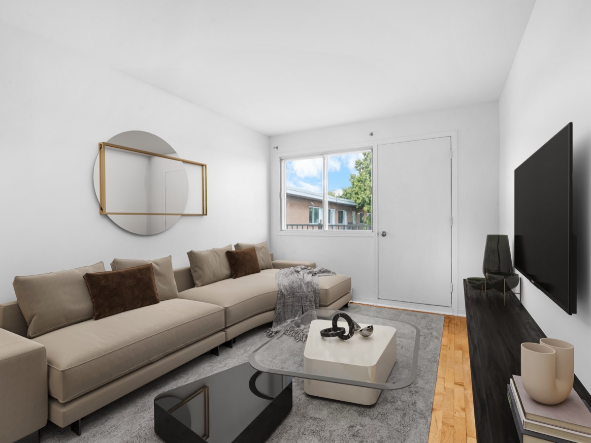Staged living room with sofa and television